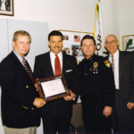 Rep. Carlos Valdes receives 1996 Metro Dade Police Department Certificate of Appreciation for outstanding support of law enforcement operations from Director Carlos Alvarez and Major George Aylesworth.