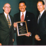 Major George Aylesworth and Director of Metro Dade Police Dept. Carlos Alvarez present to Rep. Carlos Valdes Legislative Award.