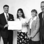 Rep. Carlos Valdes, Chairman of Business Development & International Trade Committee presents a $1,000.00 scholarship check to Evelyn Parra a senior in the College of Business Administration at Florida International University.